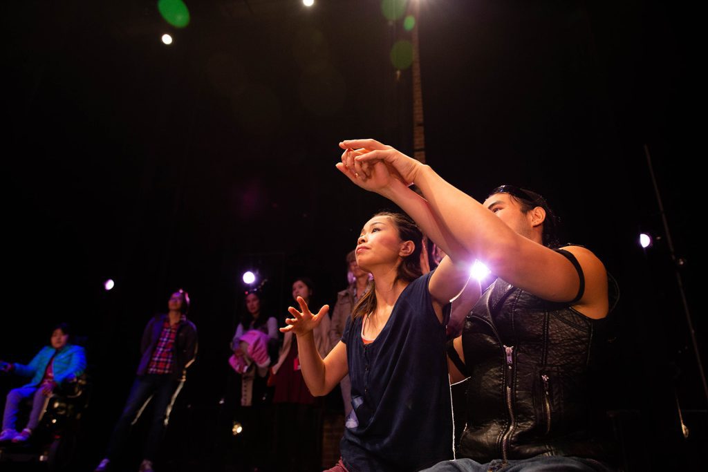 Yuko Monden Juma leads a blind audience member in a pre-show touch tour.