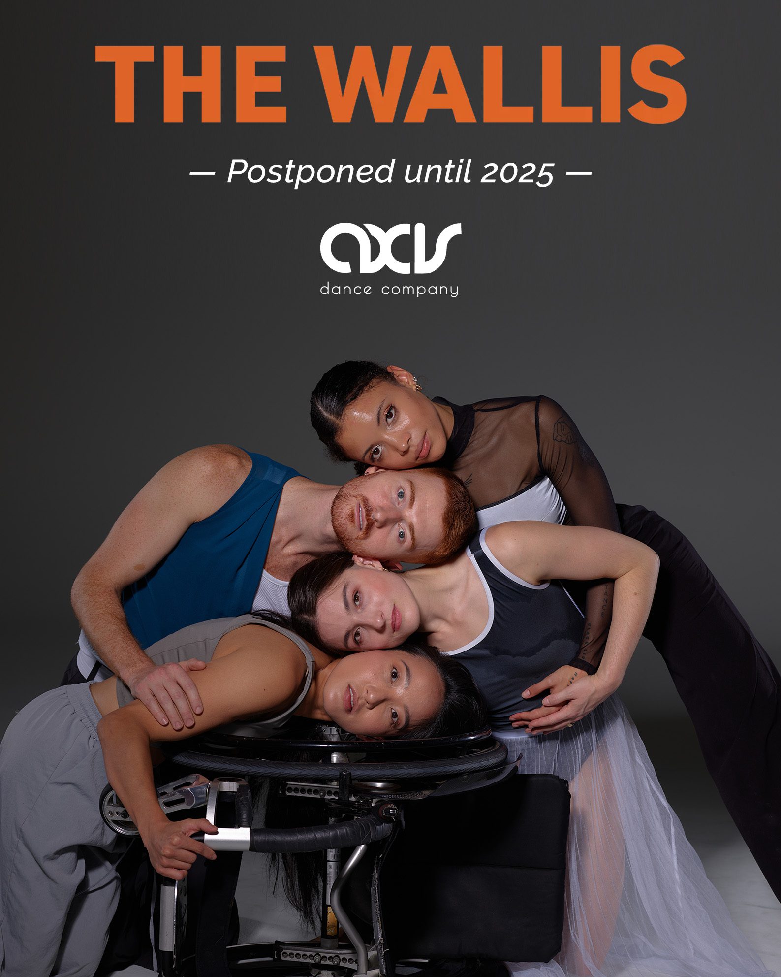 Four dancers stack their heads on top of each other with tenderness; Julie places her head on a wheel of her wheelchair at the bottom, which is turned over on it's side. The dancers wear costumes in grey, blue and iridescent white on a grey background; text reads "Postponed until 2025" with the Wallis and AXIS logos.